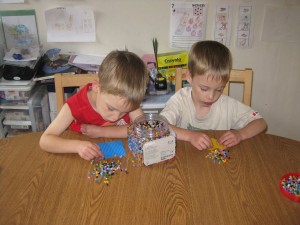Zander and Gavin Placing Their Beads